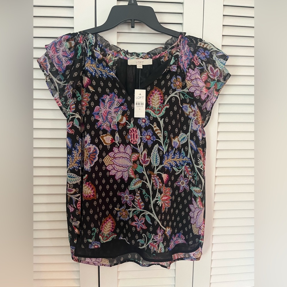 Lightweight printed top with flutter sleeves.